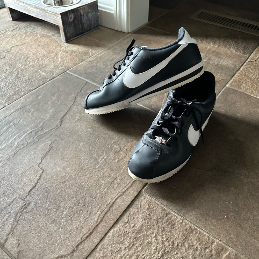 Black and white Cortez Nike shoes.
